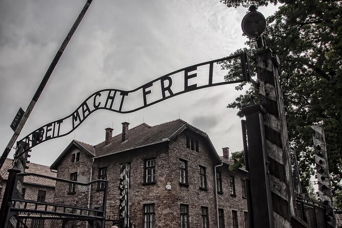 From Warsaw: Auschwitz-Birkenau Tour with Premium Train Transportation - Krakow handoff: van ride plus a local guide at the site