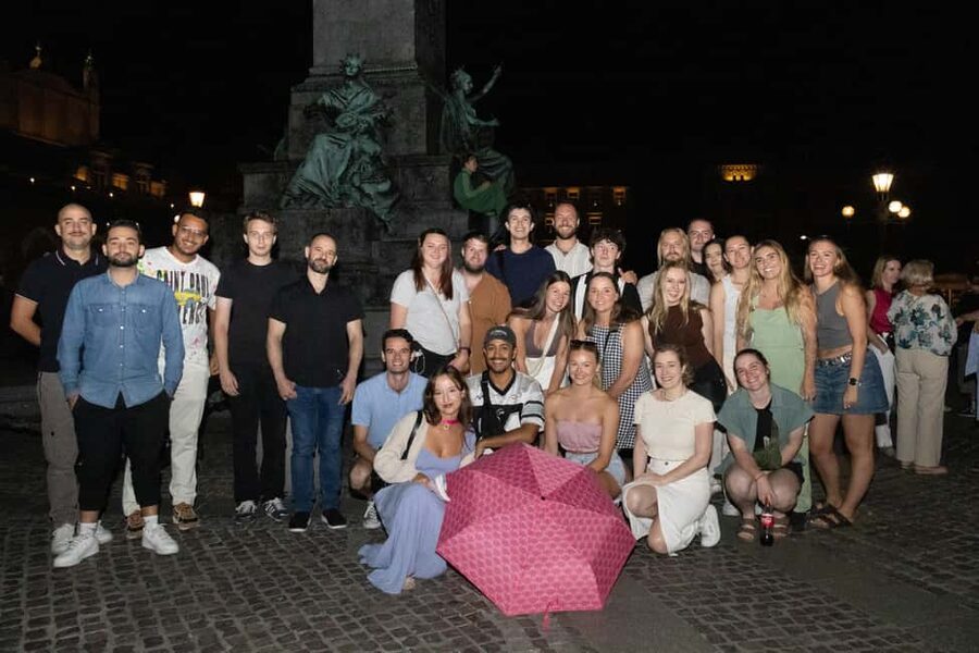 Krakow: Pub Crawl 1H Open Bar, VIP Entry & Welcome Shots - Meet by Adam’s Statue, then let the pink umbrella herd begin