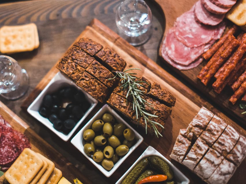 Krakow: Vodka Tasting Tour: Tapas, Tipsy Tales & Hidden Gems - Your first stop: tapas, crusty bread, and two clear vodkas