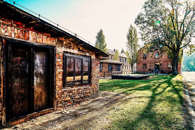 Self-Guided Tour of Auschwitz-Birkenau Museum with Transportation - Auschwitz I: entering through the Arbeit Macht Frei gate with headset audio